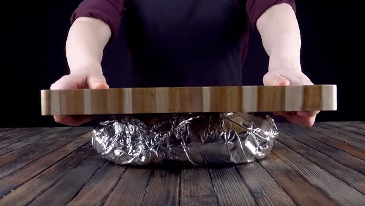 Wrap the loaf in foil and press down well with the board.