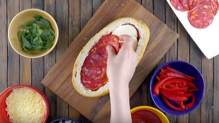 On top of the cheese we spread the circles of salami.