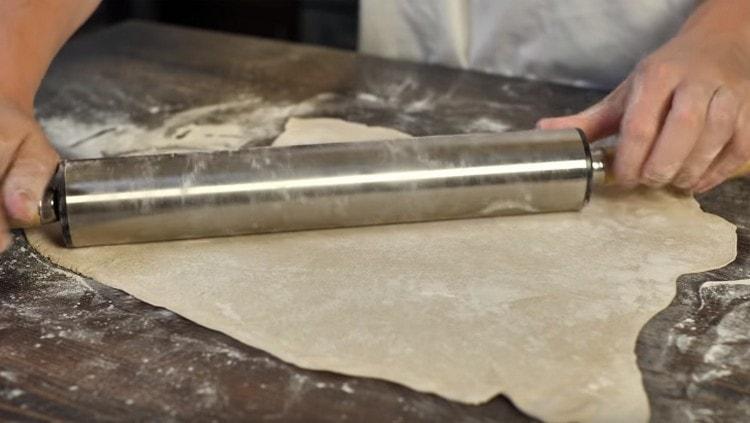 Roll out the dough with a rolling pin.