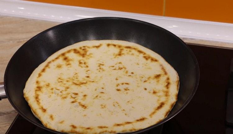 Turn the cake over and remove the pan from the heat.