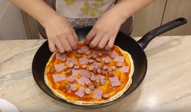 We spread slices of sausage and ham.