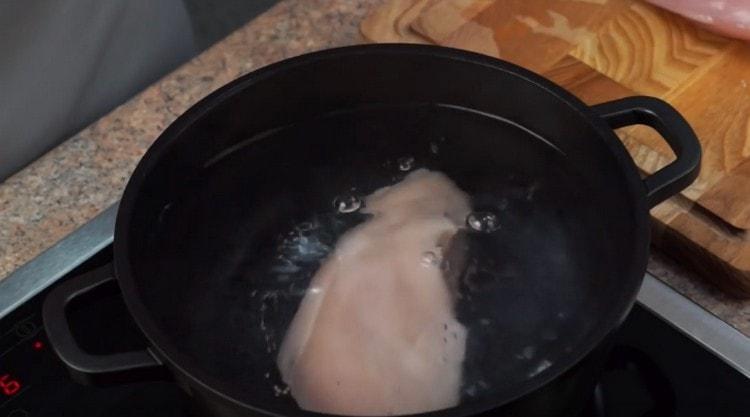 Boil until tender chicken fillet.
