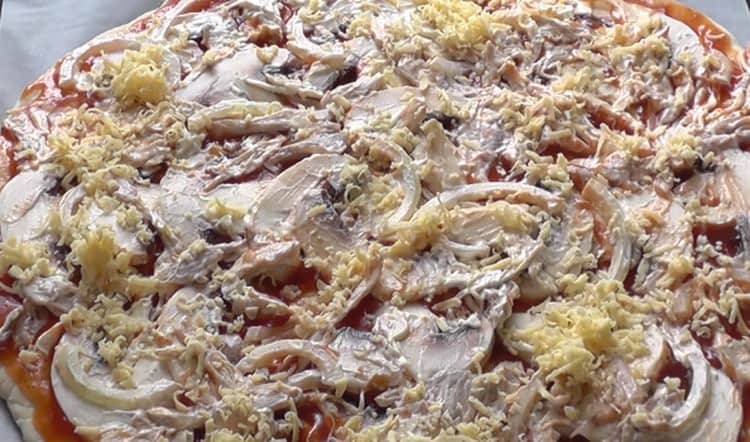 Sprinkle pizza with cheese and put in the oven.