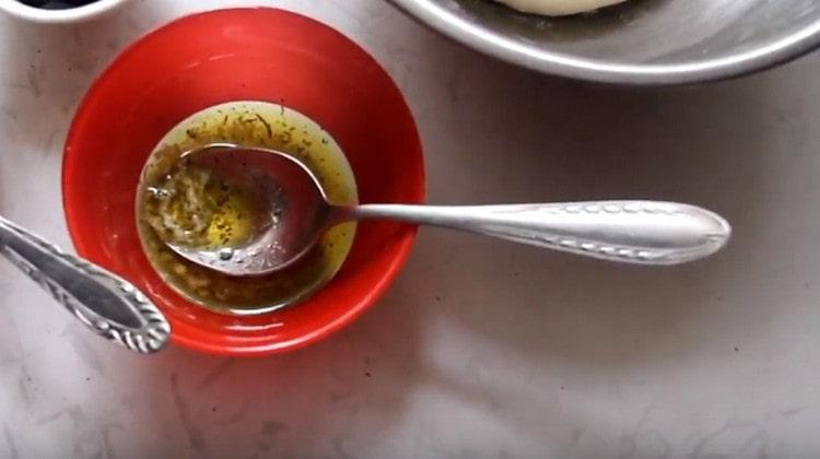 We add Italian herbs and chopped garlic to olive oil.