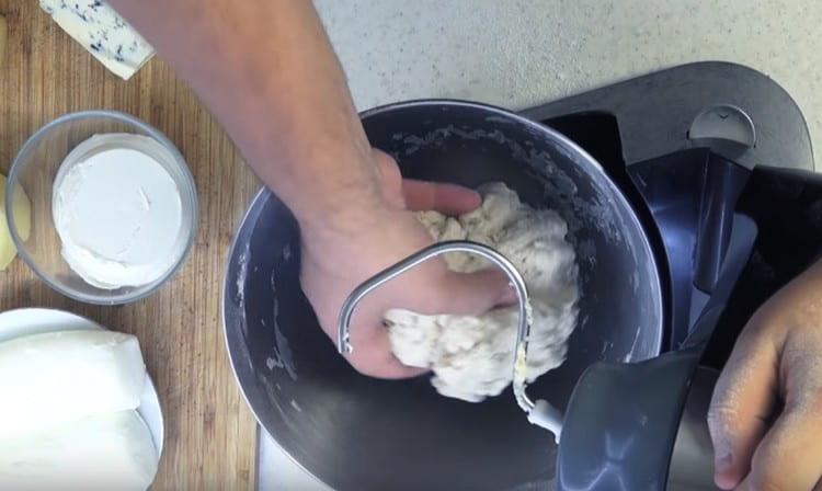 Combine the flour with liquid components and knead the dough.