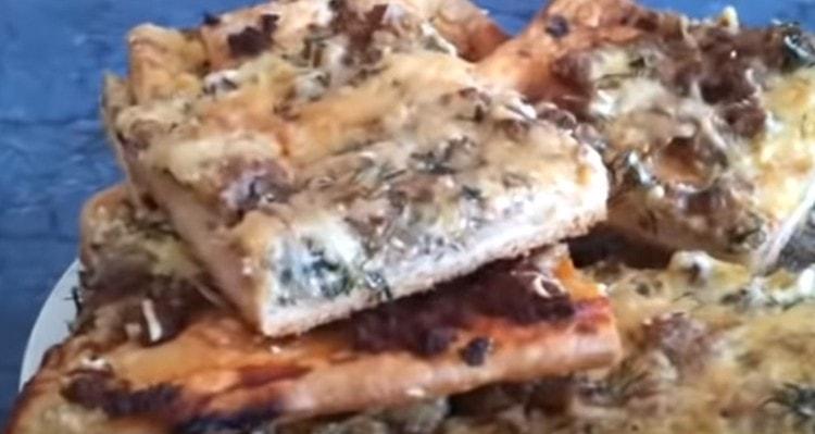 Homemade pizza with minced meat is ready.