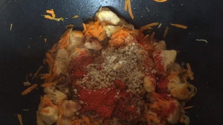 Add spices to the pilaf, as well as chopped walnuts.
