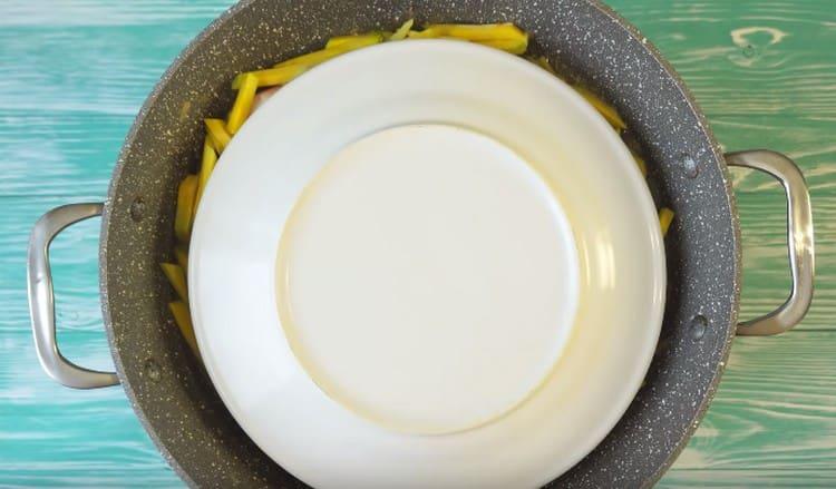 Cover with a plate and cook.