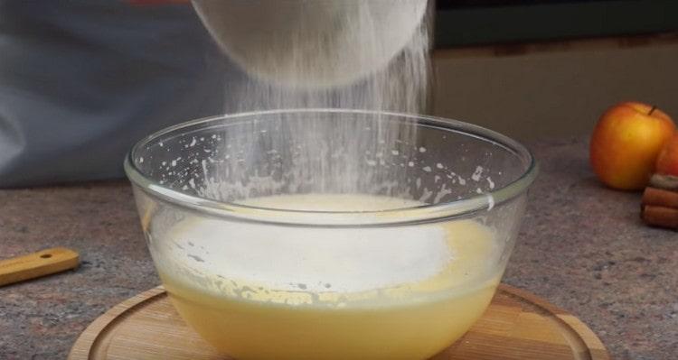 Sift flour into the lush egg mass.