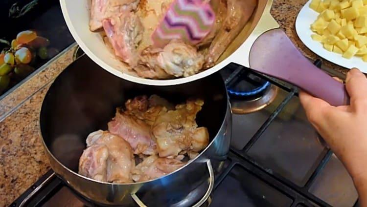 The fried meat is transferred to the pan.