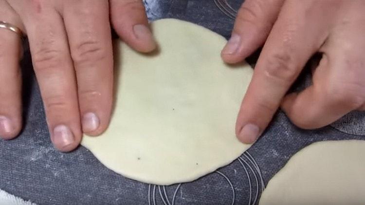 Each piece of dough is rolled into a cake.