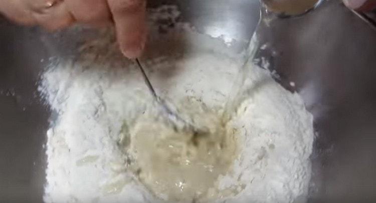 Stirring the dough, add water to it.