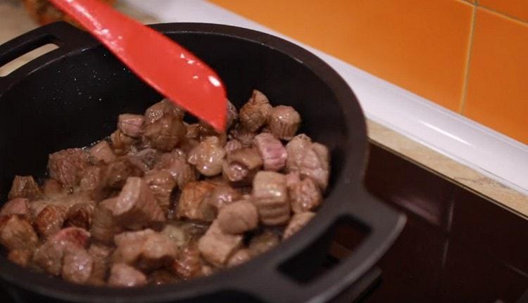 Fry the meat until golden brown.