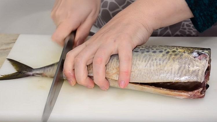 We clean the fish, cut off the fins and tail.