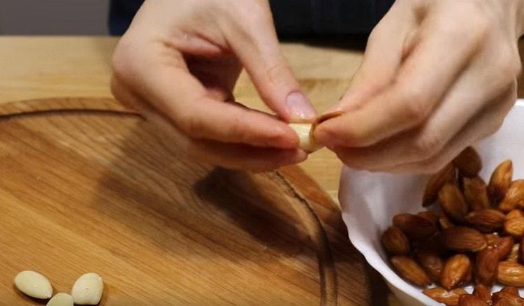 Drain almond water and easily peel it.