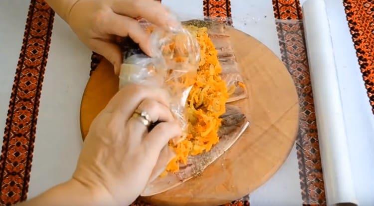 Twist the roll in the film.