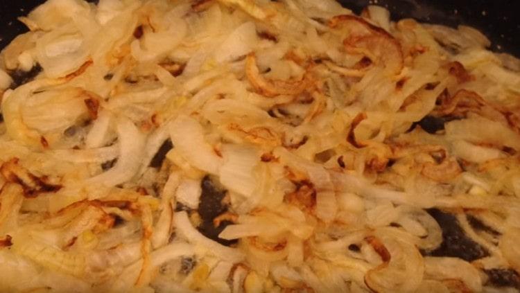 Fry the onion in a pan until golden brown.