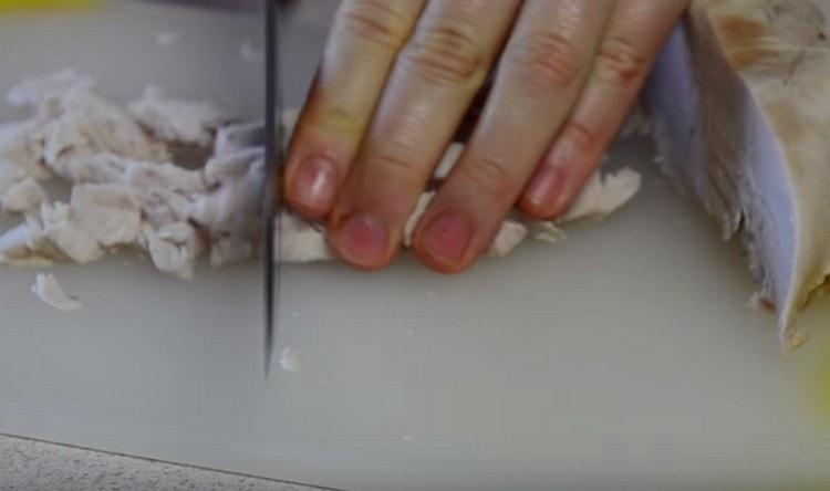 Dice the boiled chicken fillet.