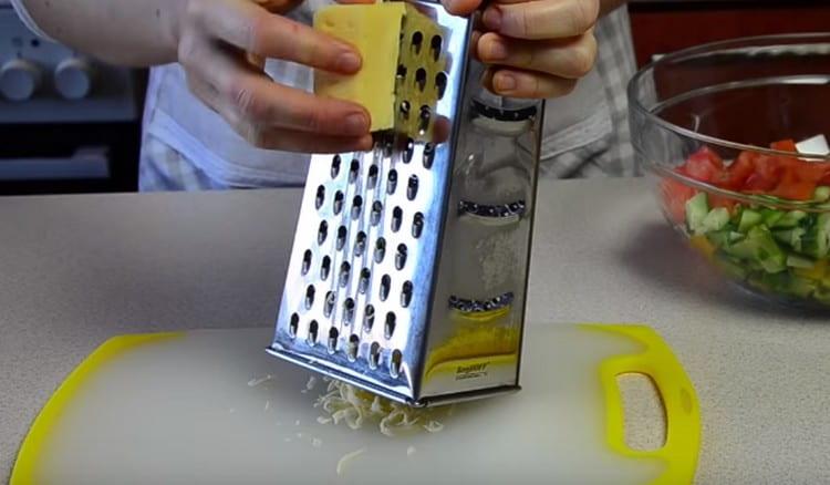Grate hard cheese on a coarse grater.