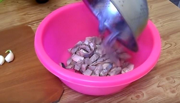 We flip the herring into a colander and transfer it to a roomy bowl.