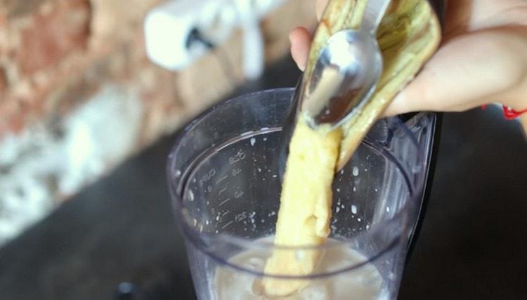 The last thing we add is a baked banana and once again interrupt it all with a blender.