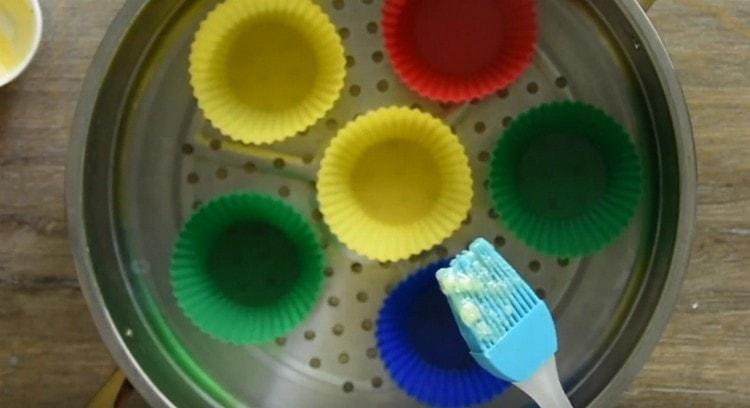 Grease silicone molds with melted butter.