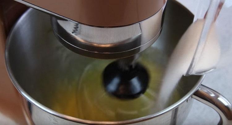 Gradually add sugar to the eggs.