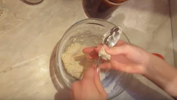 Carefully remove the dough adhering to the spoon with your hands.