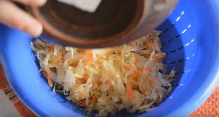 We discard the washed cabbage in a colander.