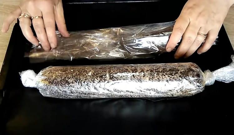 Spread stuffed pike on a baking sheet.