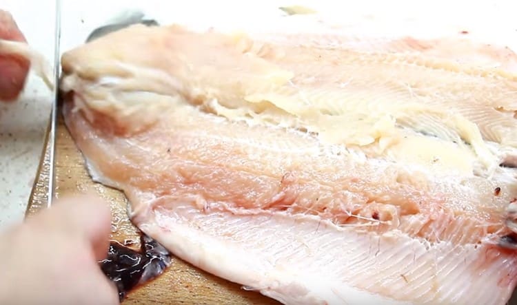 Carefully cut the trout fillet from the ridge.