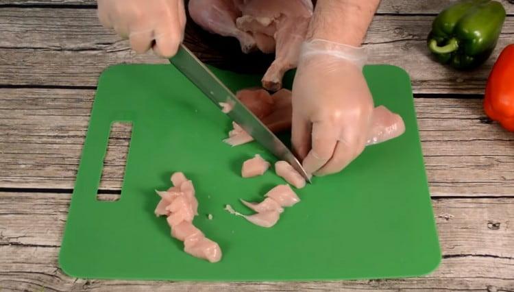First, cut the chicken into small pieces.