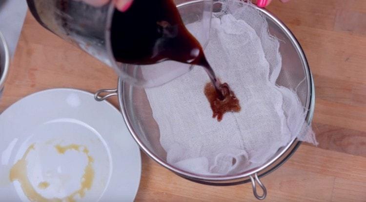 The prepared coffee concentrate passes through a gauze covered sieve.