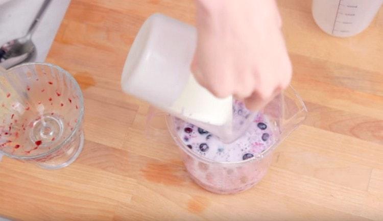 Add milk and blueberries to the berries.