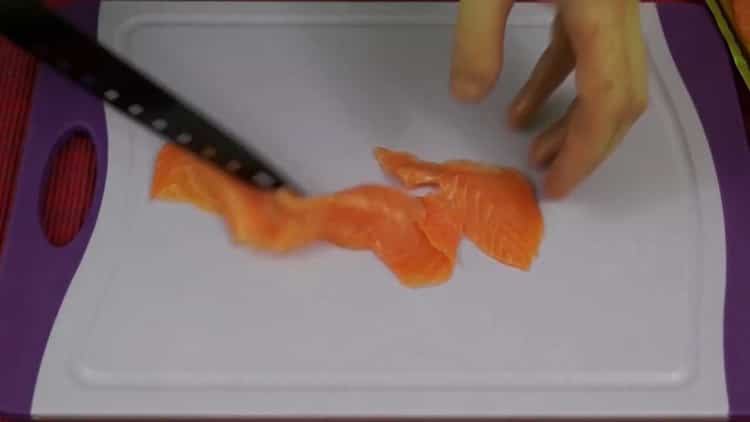 To make sandwiches with avocado and red fish, chop the ingredients