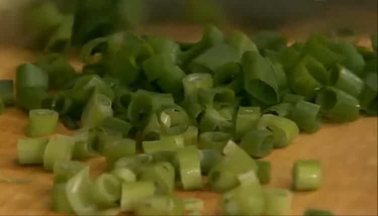 According to the recipe, to prepare the hake fillet, chop the onion