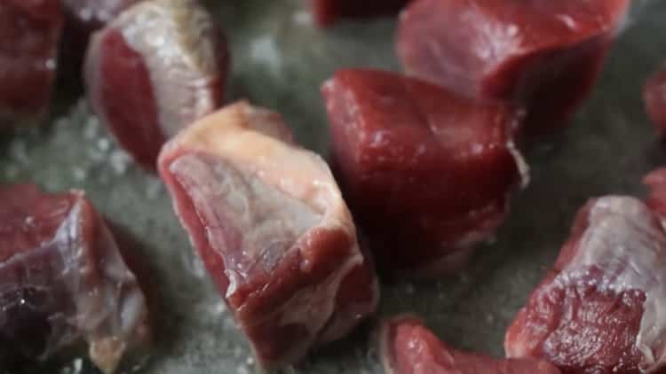 To cook beef stew with vegetables, saute the meat