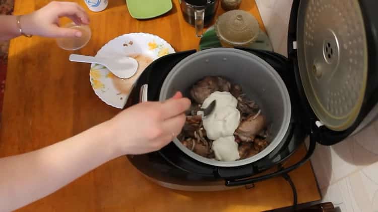 To cook a rabbit in a slow cooker in a sour cream sauce, prepare the sauce