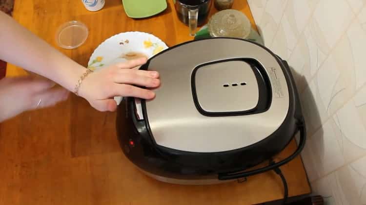 To cook a rabbit in a slow cooker in a sour cream sauce, set the desired mode