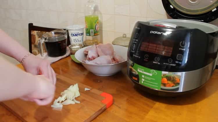 To cook a rabbit in a slow cooker in a sour cream sauce, chop the onion