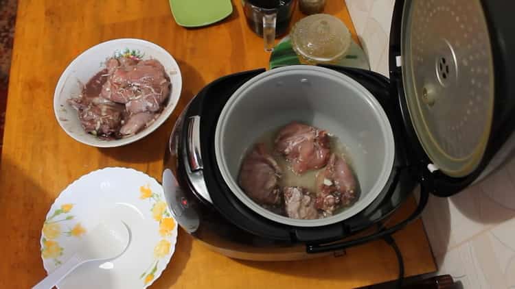 To cook a rabbit in a slow cooker in a sour cream sauce, fry the meat