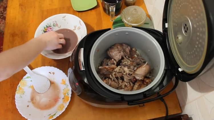 To cook a rabbit in a slow cooker in a sour cream sauce, fry the onions