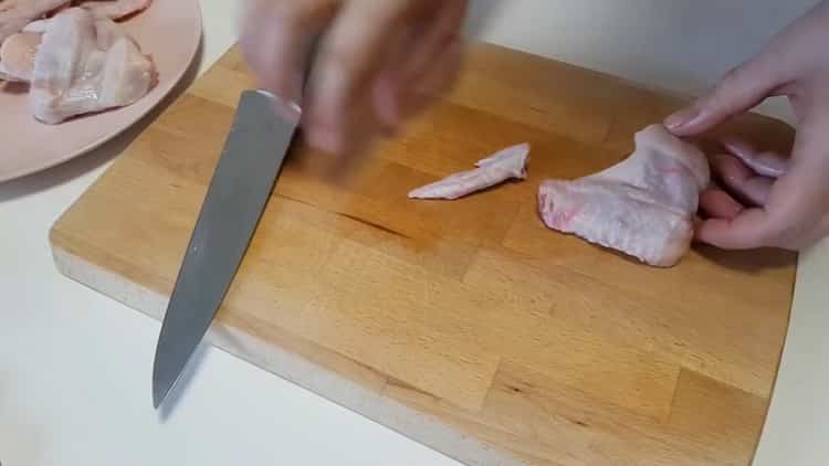 To cook chicken wings with potatoes in the oven, prepare the meat