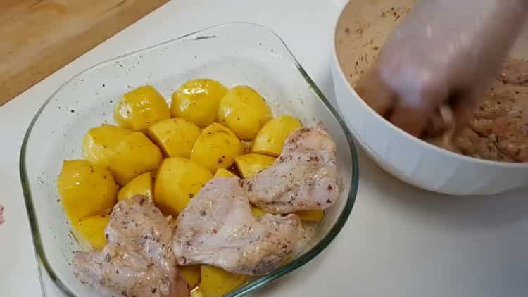 To cook chicken wings with potatoes in the oven, put the meat on the potatoes