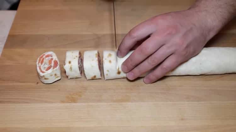 To make pita bread with red fish, cut the roll