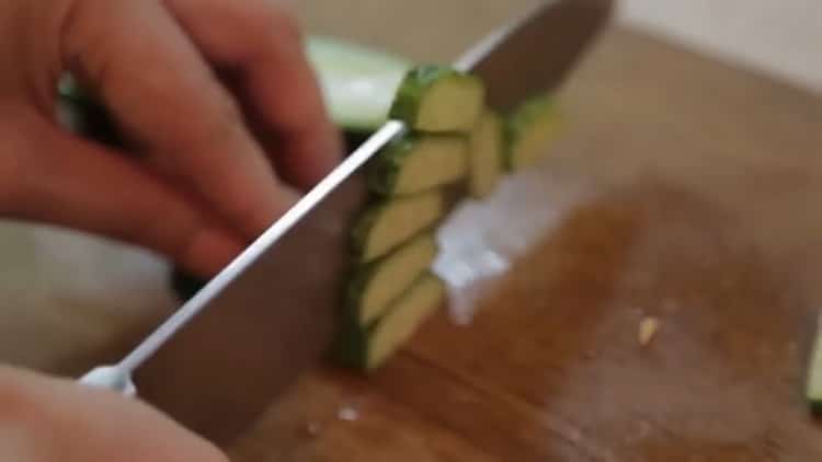 To cook salmon in the oven in a foil, cut a cucumber