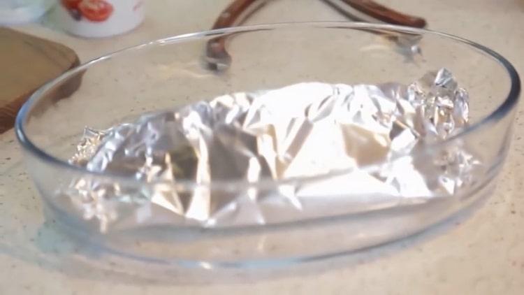 To cook salmon in the oven in a foil, preheat the oven