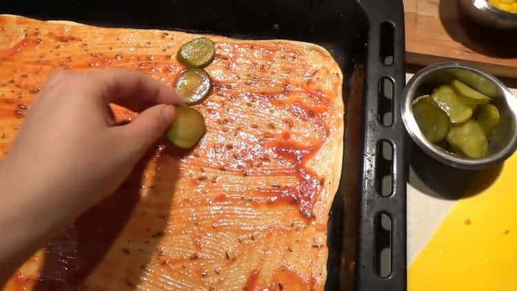 To make the pizza toppings, put the cucumbers on the dough