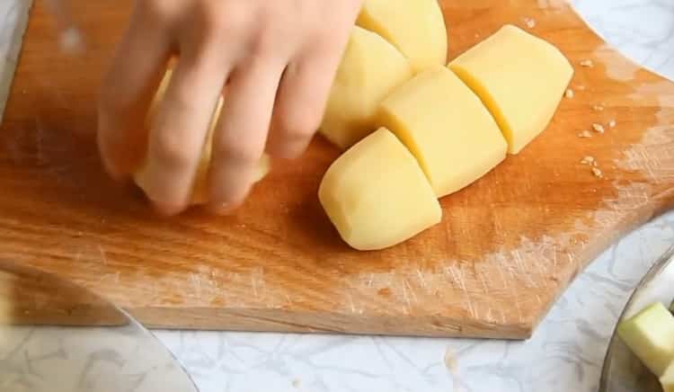 To cook vegetable stew with zucchini, cut potatoes