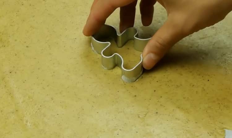 To make ginger biscuits with cinnamon, roll out the dough